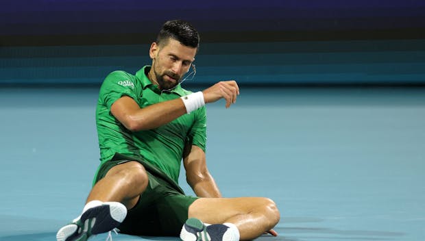 MIAMI GARDENS, FLORIDA - MARCH 30: Novak Djokovic of Serbia falls during the men's singles final against Jakub Mensik of the Czech Republic on the final day of the Miami Open Presented by Itau 2025 at Hard Rock Stadium on March 30, 2025 in Miami Gardens, Florida. (Photo by Al Bello/Getty Images)