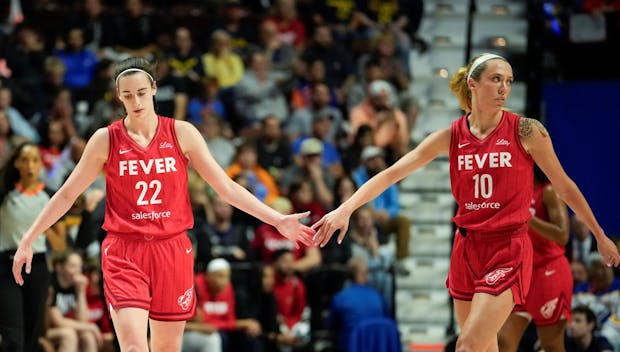 UNCASVILLE, CONNECTICUT - SEPTEMBER 25: Caitlin Clark #22 of the Indiana Fever and teammate Lexie Hull #10 show camaraderie as they play the Connecticut Sun during the first quarter of Game Two of the 2024 WNBA Playoffs first round at Mohegan Sun Arena on September 25, 2024 in Uncasville, Connecticut. (Photo by Joe Buglewicz/Getty Images)