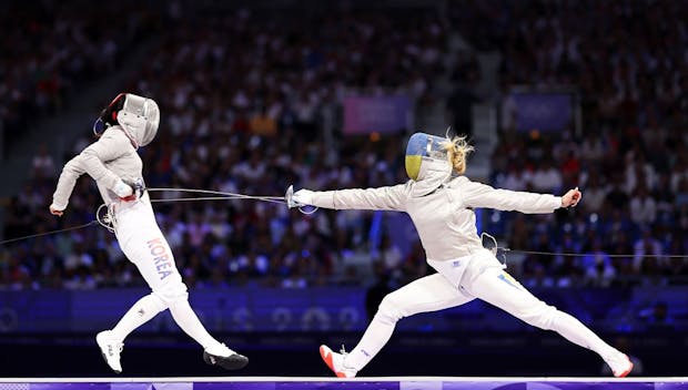 PARIS, FRANCE - AUGUST 03: Eunhye Jeon of Team Republic of Korea (L) Olga Kharlan of Team Ukraine (R) compete during the Fencing Women's Sabre Team Gold Medal match on day eight of the Olympic Games Paris 2024 at Grand Palais on August 03, 2024 in Paris, France. (Photo by Ezra Shaw/Getty Images)