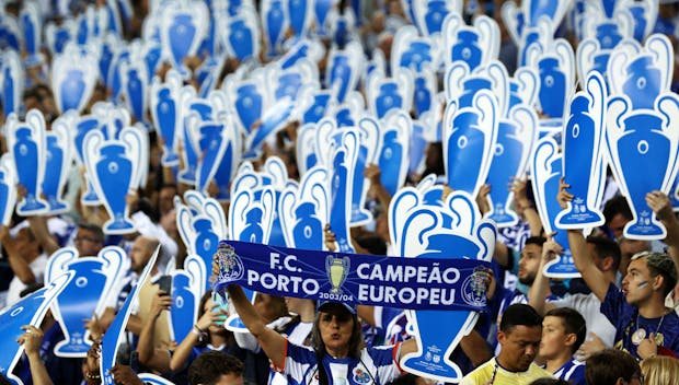 PORTO, PORTUGAL - OCTOBER 04: Fans of FC Porto hold cardboard cutouts of the UEFA Champions League trophy during the UEFA Champions League match between FC Porto and FC Barcelona at Estadio do Dragao on October 04, 2023 in Porto, Portugal. (Photo by Carlos Rodrigues/Getty Images)