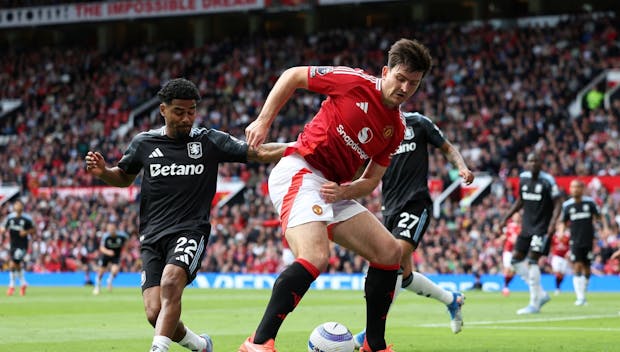 MANCHESTER, ENGLAND - MAY 25: Harry Maguire of Manchester United battles for possession with Ian Maatsen of Aston Villa during the Premier League match between Manchester United FC and Aston Villa FC at Old Trafford on May 25, 2025 in Manchester, England. (Photo by Matt McNulty/Getty Images)